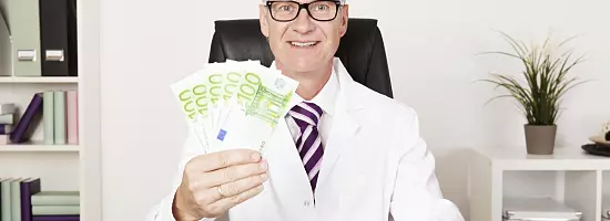Happy Physician Holding Cash - Sebastian Gauert - stock.adobe.com